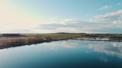 Aerial Fly Over Small Lake Towards Distant Hills Stock Footage 131276327