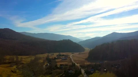 Aerial fly over a small town near a mountain road Stock Footage 201149928