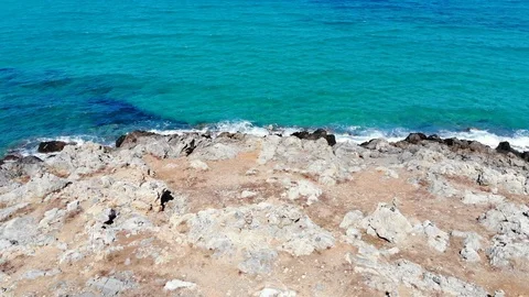 Aerial fly over stony beach and blue sea, Crete Greece Stock Footage 100988528