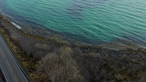 Aerial fly over tilted shot with view of islands and coastal road in northen Видео 126539381