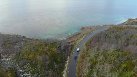 Aerial fly over tilted shot with view of islands and coastal road in northen Видео 126541995