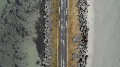 Aerial fly over tilted shot with view of islands and coastal road in northen Video stock 126544136