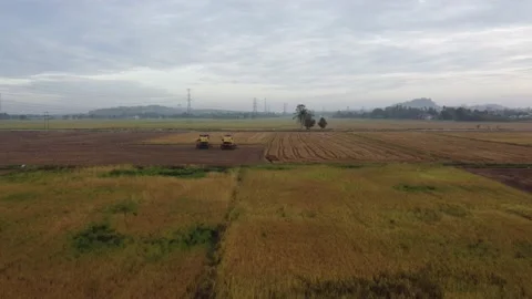 Aerial fly over two harvester park Stock Footage 197010786