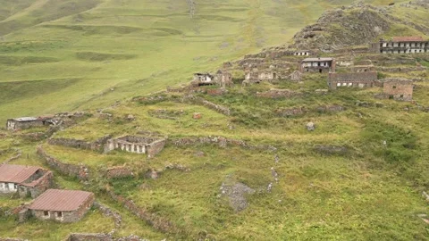 Aerial fly over view abandoned village of Arsha ruins on hillside. Kazbegi .. Stock Footage 284326799