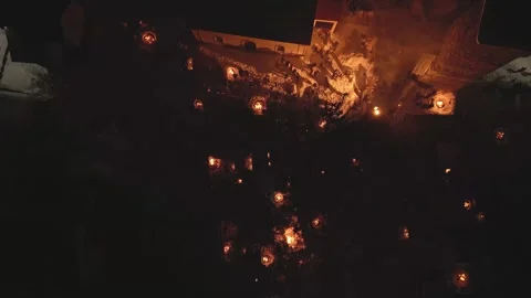 Aerial fly over view Lamproba festival, villagers gathered by symbolic bonf.. Stock Footage 312060342