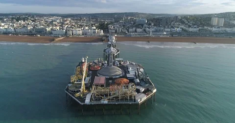 Aerial fly over view of the palace pier in Brighton, early morning Stock Footage