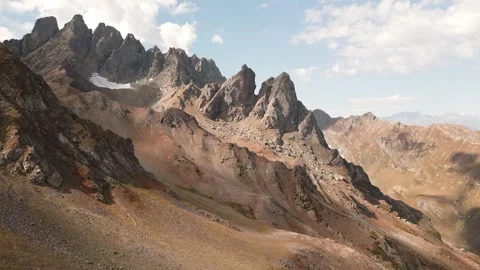 Aerial fly over view Stunning winding through rugged mountain peaks with pa.. Stock Footage 287024870
