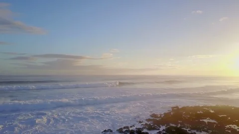 Aerial Fly Over Of Waves Breaking Over Rocks At Sunrise Vídeo Stock 78075498