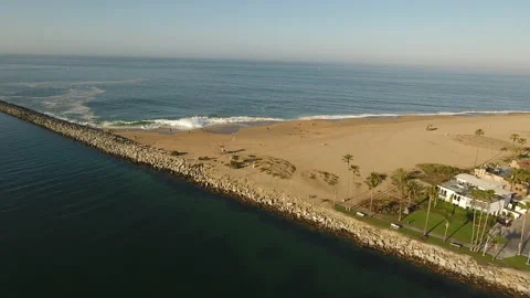Aerial fly over of waves breaking on the shore inside a jetty Stock Footage 157129381