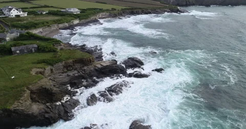 Aerial fly over of waves breaking on coastline, 4K Stock Footage 165079512