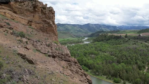 Aerial Fly Pass Sheer Cliff Revealing River And Mountains In View Stock-Footage 315224945