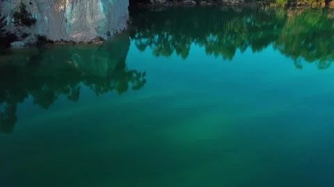 Aerial fly through beautiful hidden lake forest 動画素材 131760144