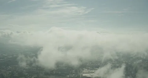 Aerial fly through clouds with city below Stock Footage 145953485