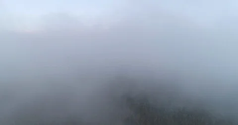 An aerial fly through the clouds looking back at Fox Glacier Mountain Range on Video stock 100126176