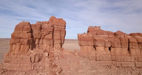 Aerial fly through giant red rock pillars in Arizona desert Stock Footage 100075366