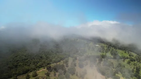 Aerial fly through low cloud misty layer near Poas Costa Rica with sunny sky Video stock 330209762