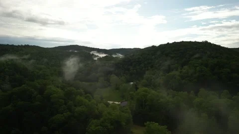 Aerial fly through low clouds in Julien West Virginia mountains in springtime Stock Footage 310262538