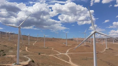 Aerial fly through of many wind turbines in California high desert Stock Footage 254214135