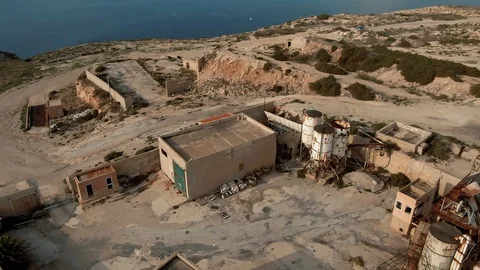 Aerial fly through over an abandoned mining plant in Lampedusa (Italy) Stock Footage 119204068