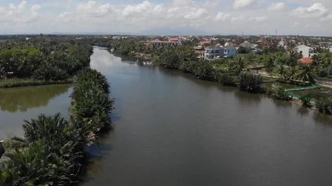 Aerial: fly trough the river by a Vietnamese village Stock Footage 101724897