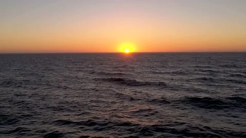 Aerial flying above ocean while the sets below the horizon during golden hour. Stock-Footage 218350625