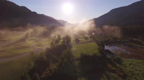 AERIAL: Flying above stunning misty mountain valley in early morning Stock Footage