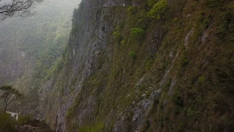 Aerial Flying Alongside Steep Cliff in Narrow Gorge Stock-Footage 101930067