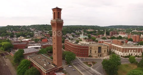 Aerial flying around a clock tower in a small town, 4K Stock Footage 64832675