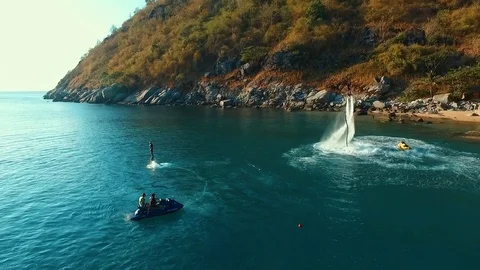 Aerial: Flying around two men on flyboard. Stock Footage 70451571
