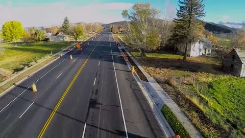 Aerial-Flying back over small town main street light morning traffic Stock Footage 69098078