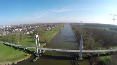 Aerial flying backwards over small white suspension bridge 4k Stock Footage 60798812