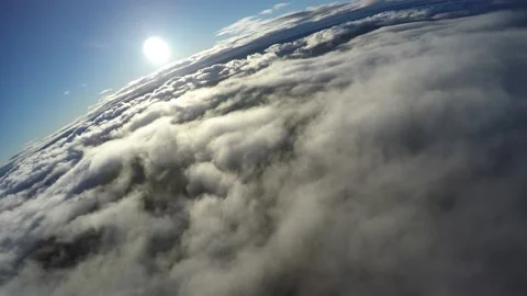 Aerial flying banking over sun lit clouds at sunset Stock Footage 237828487