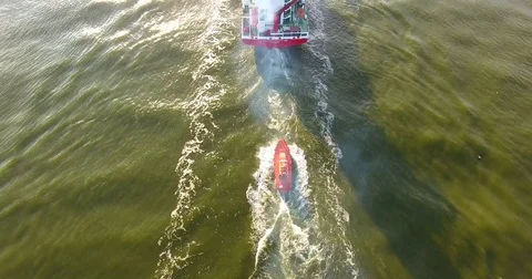 AERIAL: flying from behind the cargo ship navigate a pilot - 23 Stock Footage 80219123