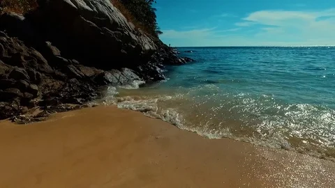 Aerial: Flying close to the cliffs forward to jet ski. Video stock 69863838