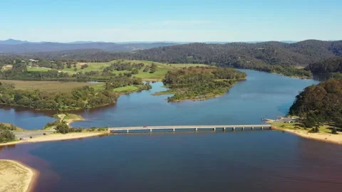 Aerial flying down to Bega river bridge and lagoon at Tathra beach aerial 4k. Stock Footage 189593265