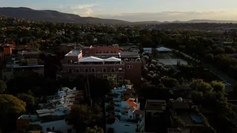 Aerial flying down of rooftop hotel in Mexican vacation town at sunset Stock Footage 147103767