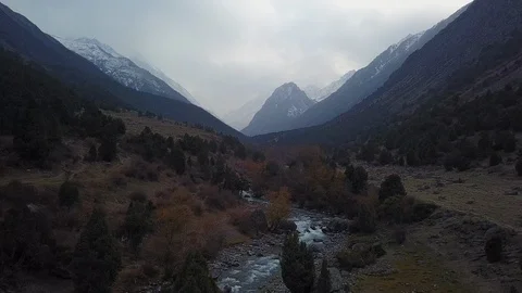Aerial Flying Forward Over River Tilt Up To Reveal Mountain Range Stock-Footage 101250862