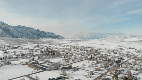 Aerial-Flying high over small rural mountain valley town with snow Stock Footage 102191476