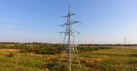 AERIAL: Flying up the high voltage electricity tower and power lines - 3 Stock Footage 80331925