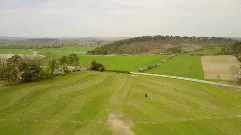 Aerial: flying over the agrarian hilly fields in La Roche Area, Belgian Ardennes Stock Footage