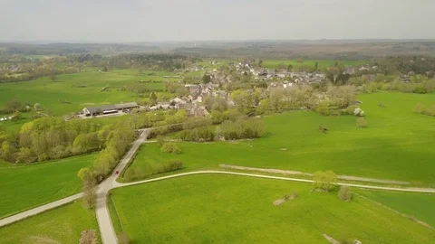 Aerial: flying over the agrarian hilly fields in La Roche Area, Belgian Ardennes Stock Footage