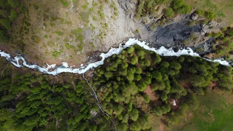 Aerial: flying over alpine valley, creek flowing in gorge Stock Footage 90837596