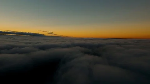Aerial flying over clouds looking a colorful dusk sky 動画素材 90558274