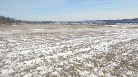 Aerial flying over corn field and backroad covered in snow Stock Footage 73483300