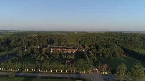 Aerial flying over a country complex located around a forest and lakes Stock Footage 101979351