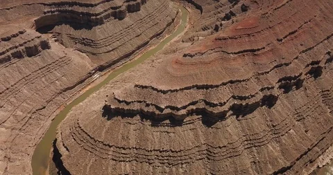 Aerial: flying over a deep river canyon in the desert Stock Footage 99448406