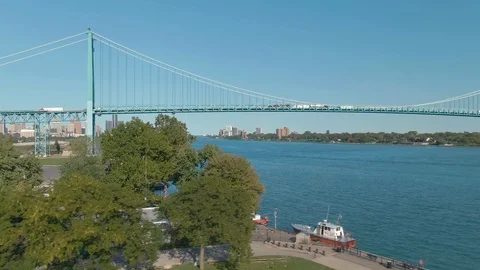 Aerial: flying over the Detroit River to the Ambassador Bridge. Detroit, USA Stock Footage