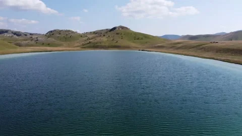 Aerial: Flying over the Devil's lake in the middle of the mountains Stock Footage 158847872