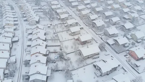 AERIAL: Flying over the empty private properties on a idyllic snowy winter day. Stock Footage 96240700