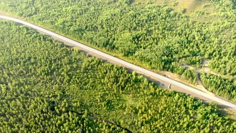 Aerial flying over an empty rural road without a car between forests. Stock Footage 138255025